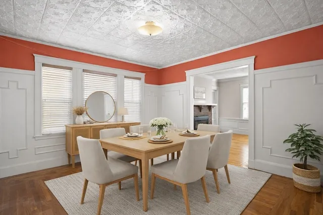 a dining room with furniture potted plants and wooden floor