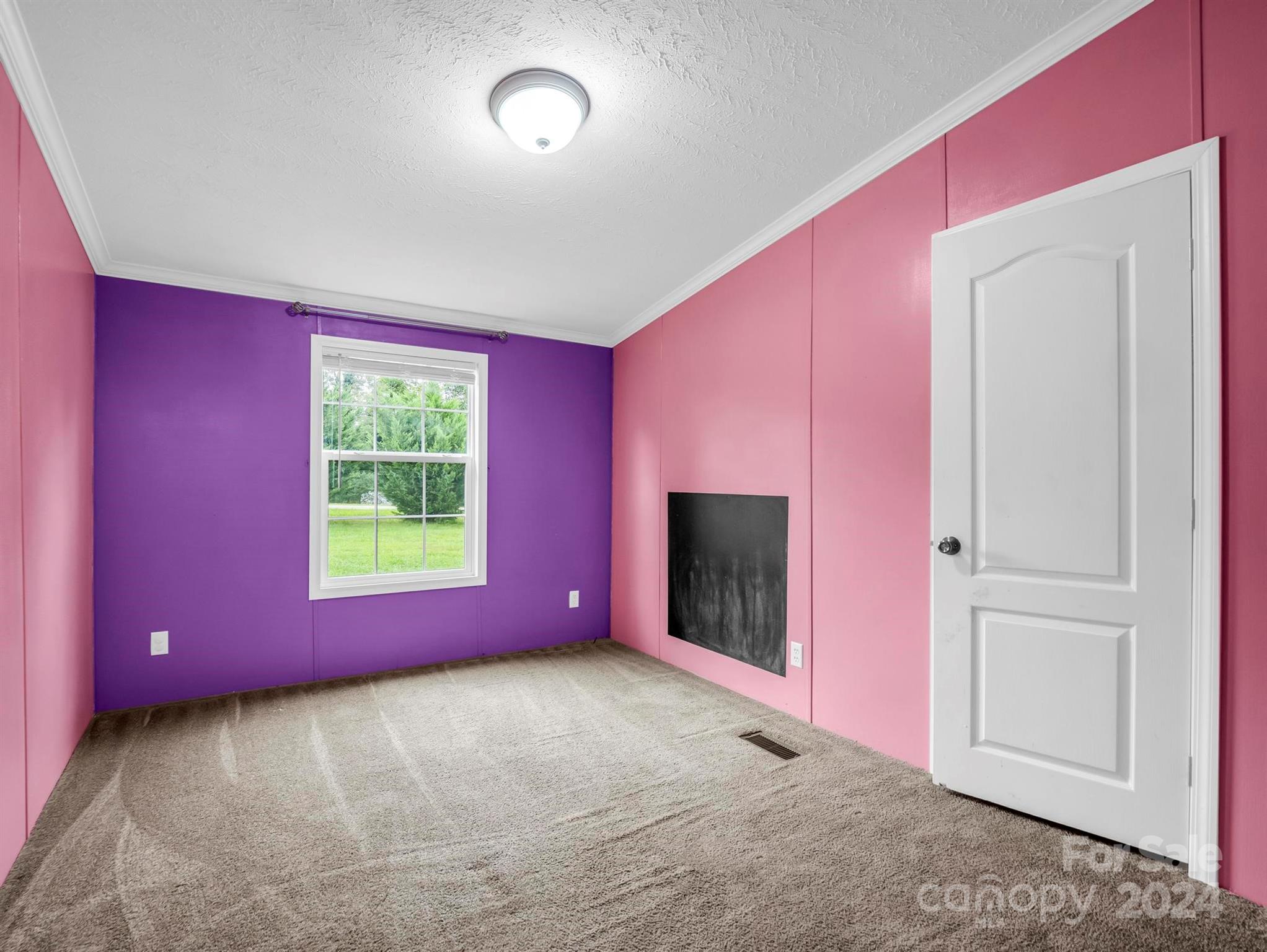 246 Abrams Moore Road Rutherfordton, NC 28139 - Photo 27 of 46 a view of an empty room with a fireplace and a window