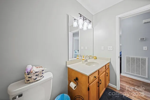 a bathroom with a sink mirror and vanity