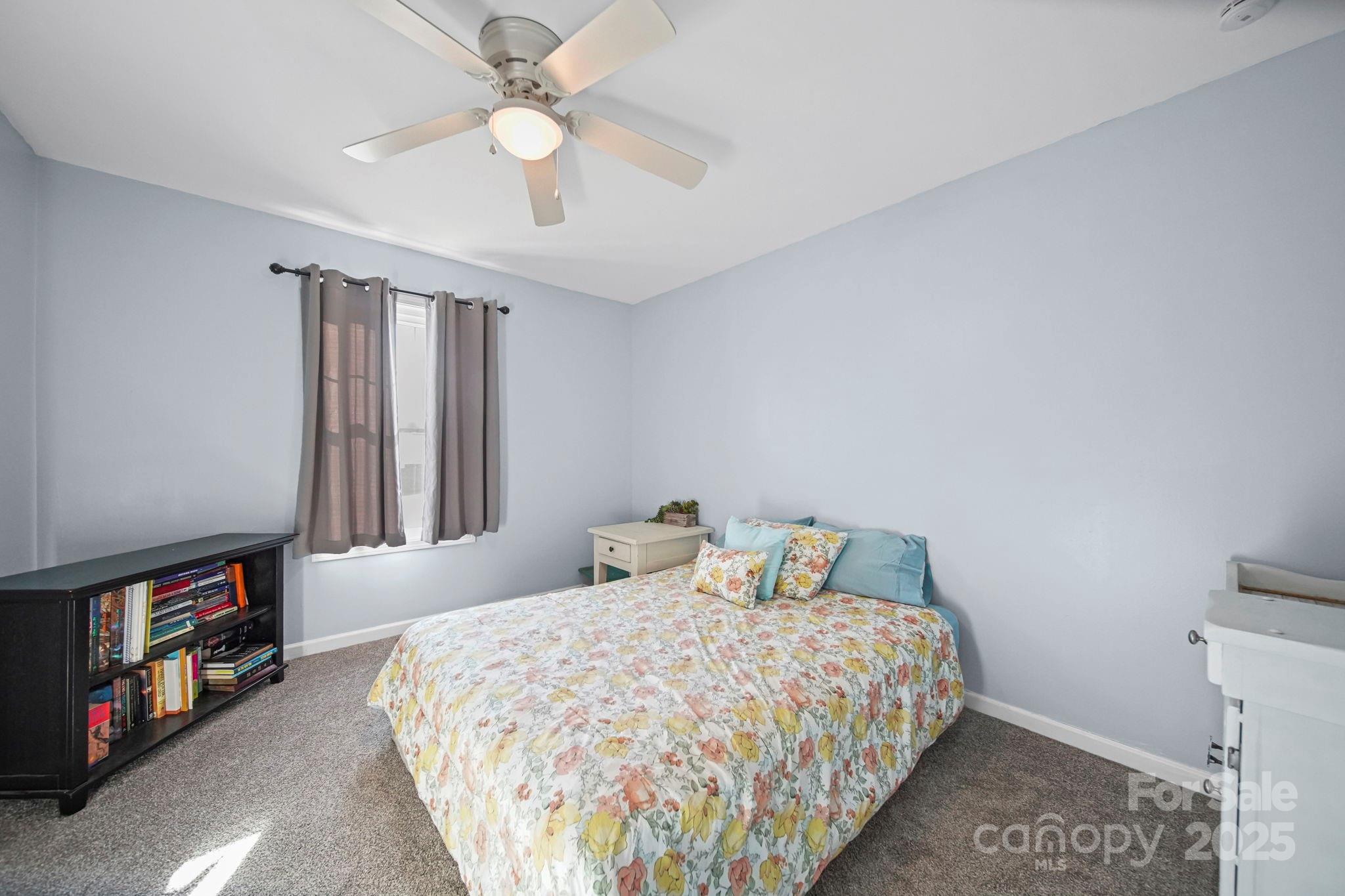 620 Pleasant Avenue Kannapolis, NC 28081 - Photo 16 of 24 a bedroom with a bed and a book shelf