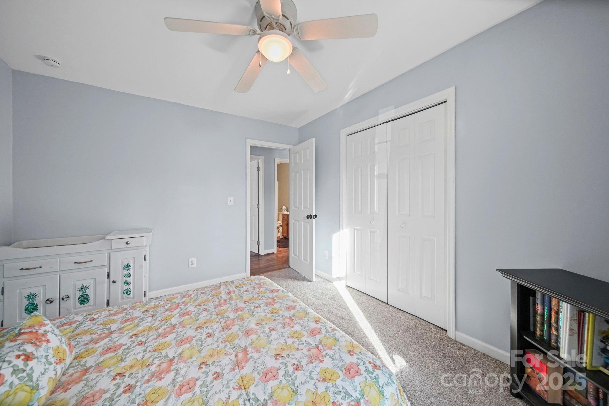 620 Pleasant Avenue Kannapolis, NC 28081 - Photo 17 of 24 a bedroom with a bed and a chandelier
