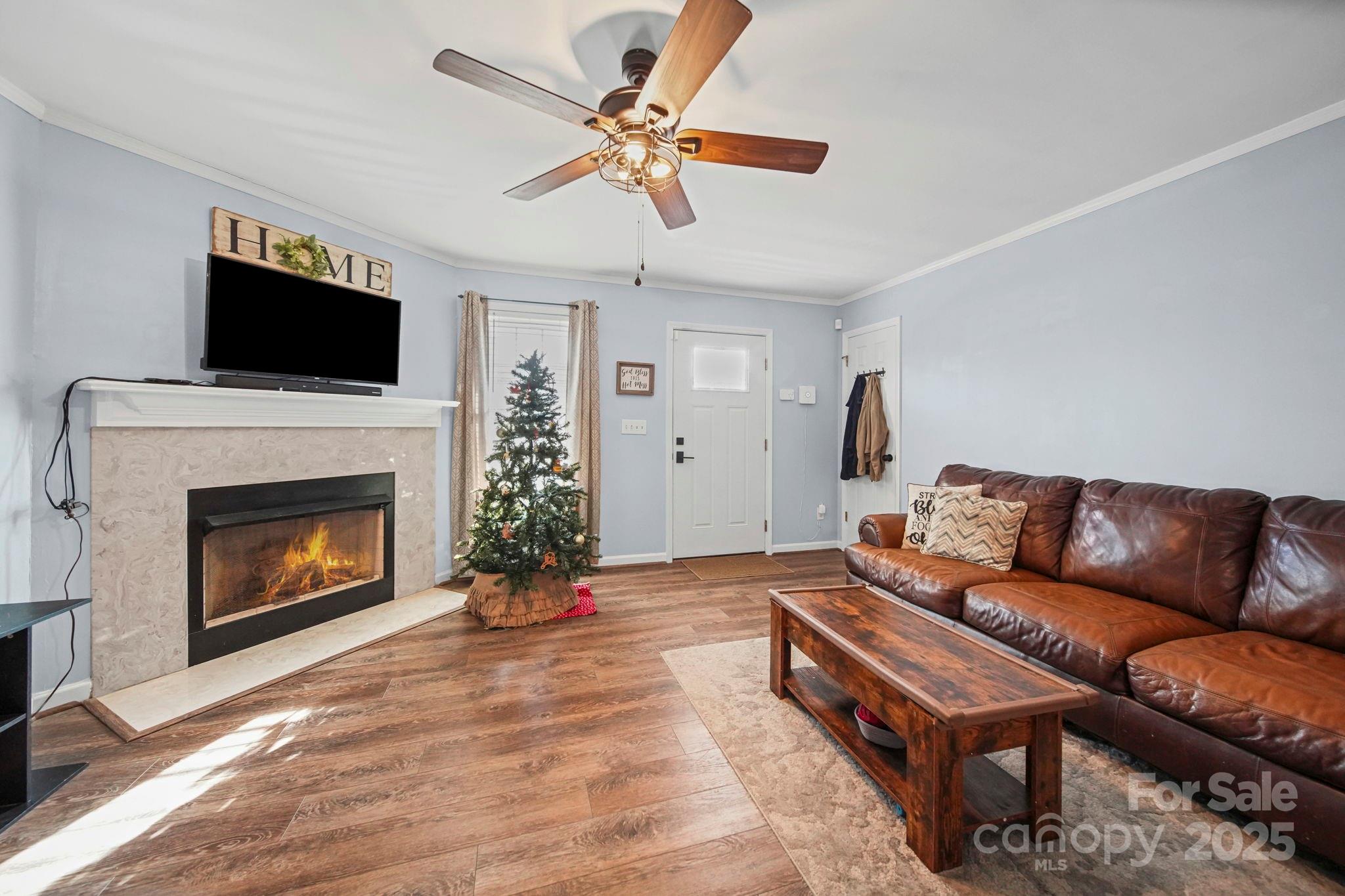 620 Pleasant Avenue Kannapolis, NC 28081 - Photo 5 of 24 a living room with furniture a flat screen tv and a fireplace