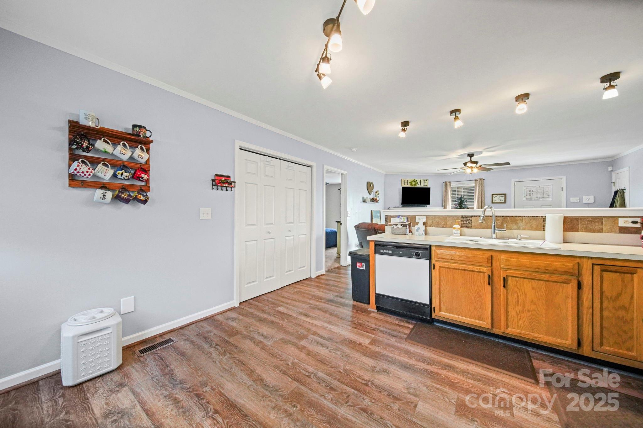 620 Pleasant Avenue Kannapolis, NC 28081 - Photo 9 of 24 a large white kitchen with a stove a sink dishwasher and a refrigerator with wooden floor