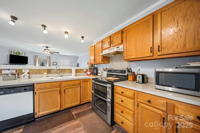 a kitchen with stainless steel appliances granite countertop a sink and cabinets