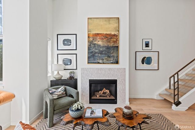 a living room with furniture wooden floor and a fireplace