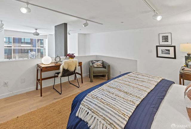 a bedroom with a bed and a chair