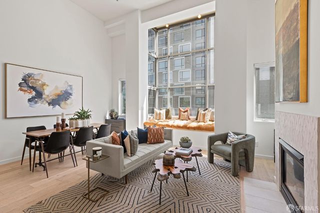 a living room with furniture a fireplace and a table