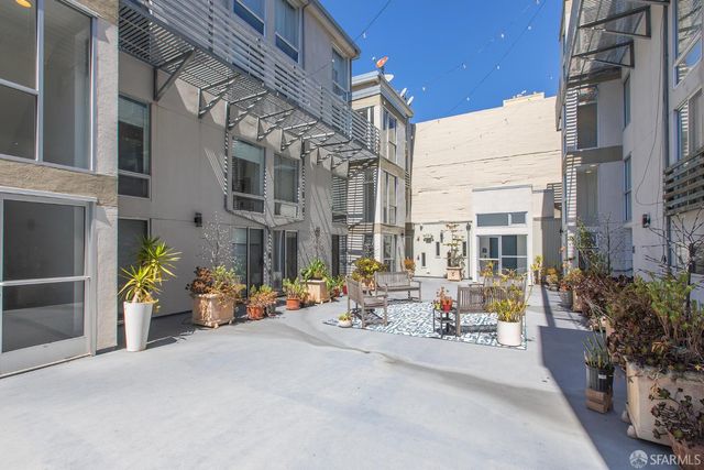 an outdoor space with lots of potted plants