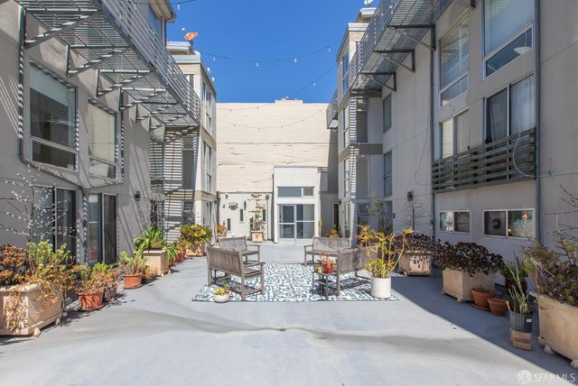 a view of a patio with a table and chairs and potted plants