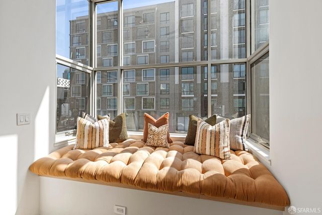 a bed sitting in a bedroom next to a large window