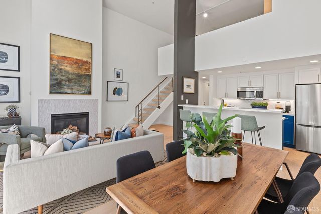 a living room with furniture potted plant and a fireplace