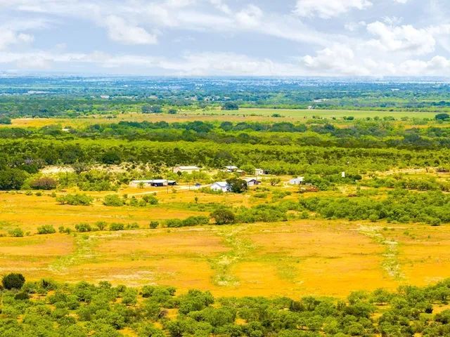 a view of a big yard and mountain