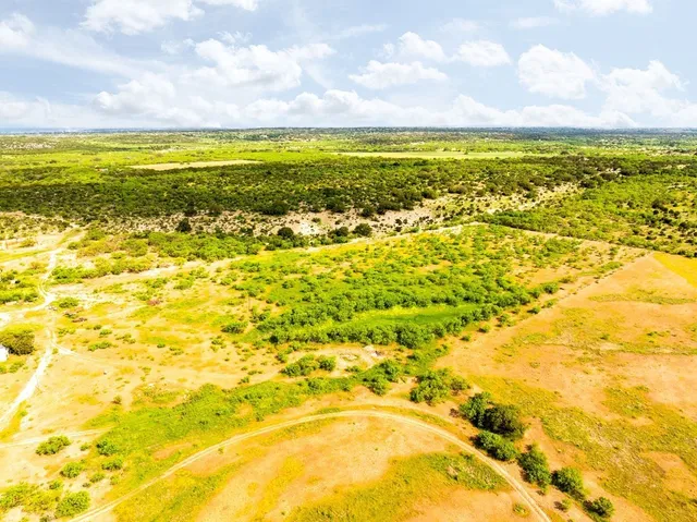 a view of a house with pool and chairs