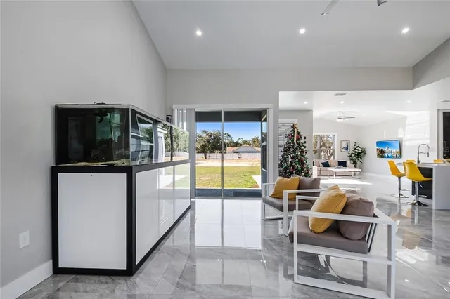 a living room with furniture a window and kitchen view