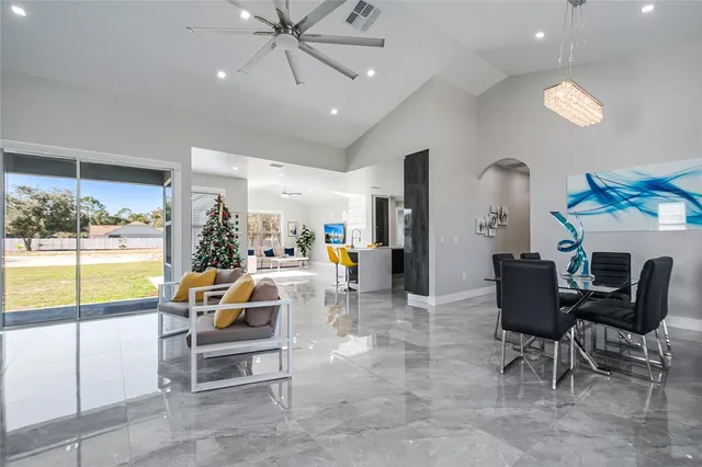 a living room with furniture and a floor to ceiling window