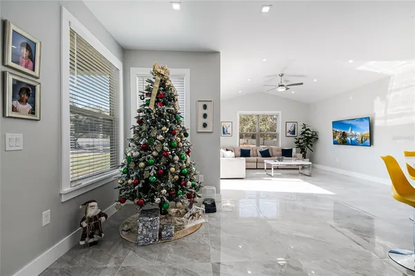 a view of a livingroom with fireplace and dining area