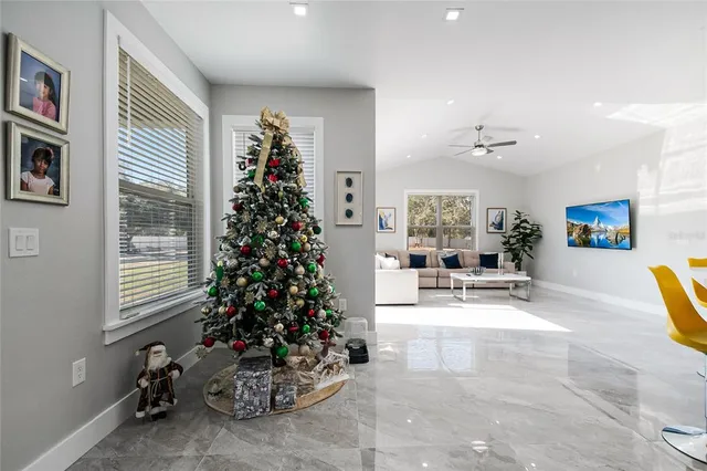 a view of a livingroom with fireplace and dining area