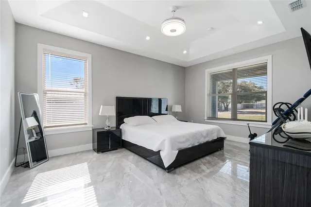 a bedroom with a bed and a large window