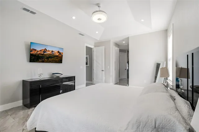 a bedroom with a bed and a flat screen tv