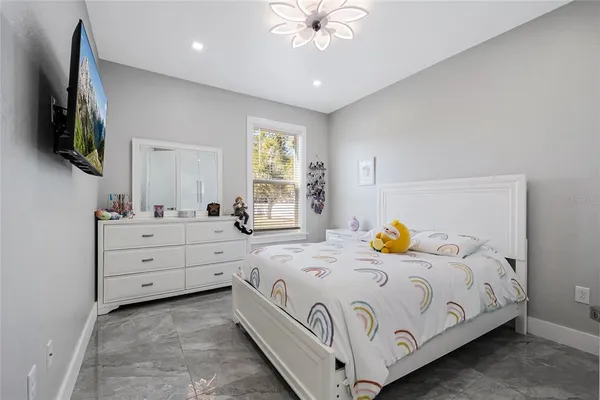a bedroom with a bed and a chandelier