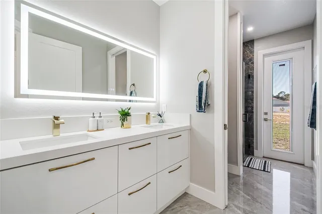 a bathroom with a sink a toilet and a shower