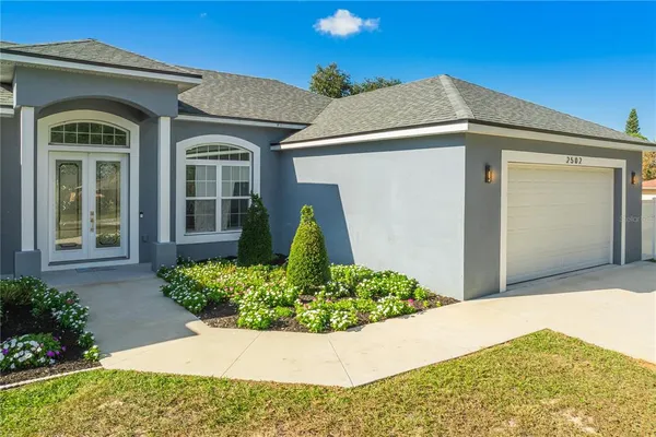 a front view of a house with garden
