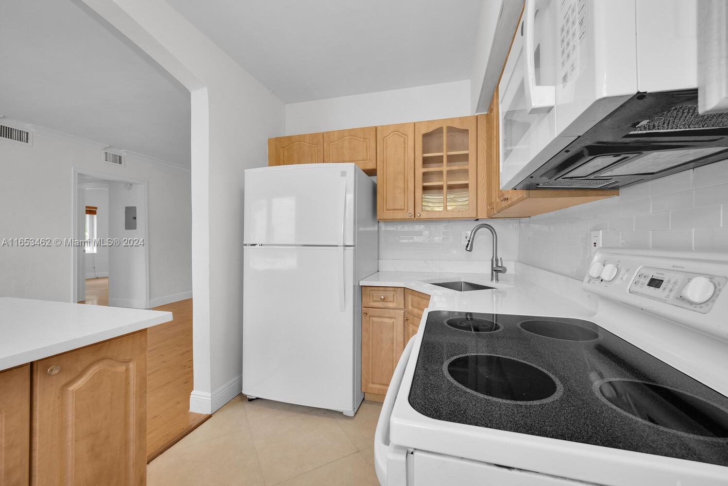 5630 Southwest 76th Street, Unit 3 Miami, FL 33143 - Photo 11 of 16 a kitchen with a refrigerator sink and stove