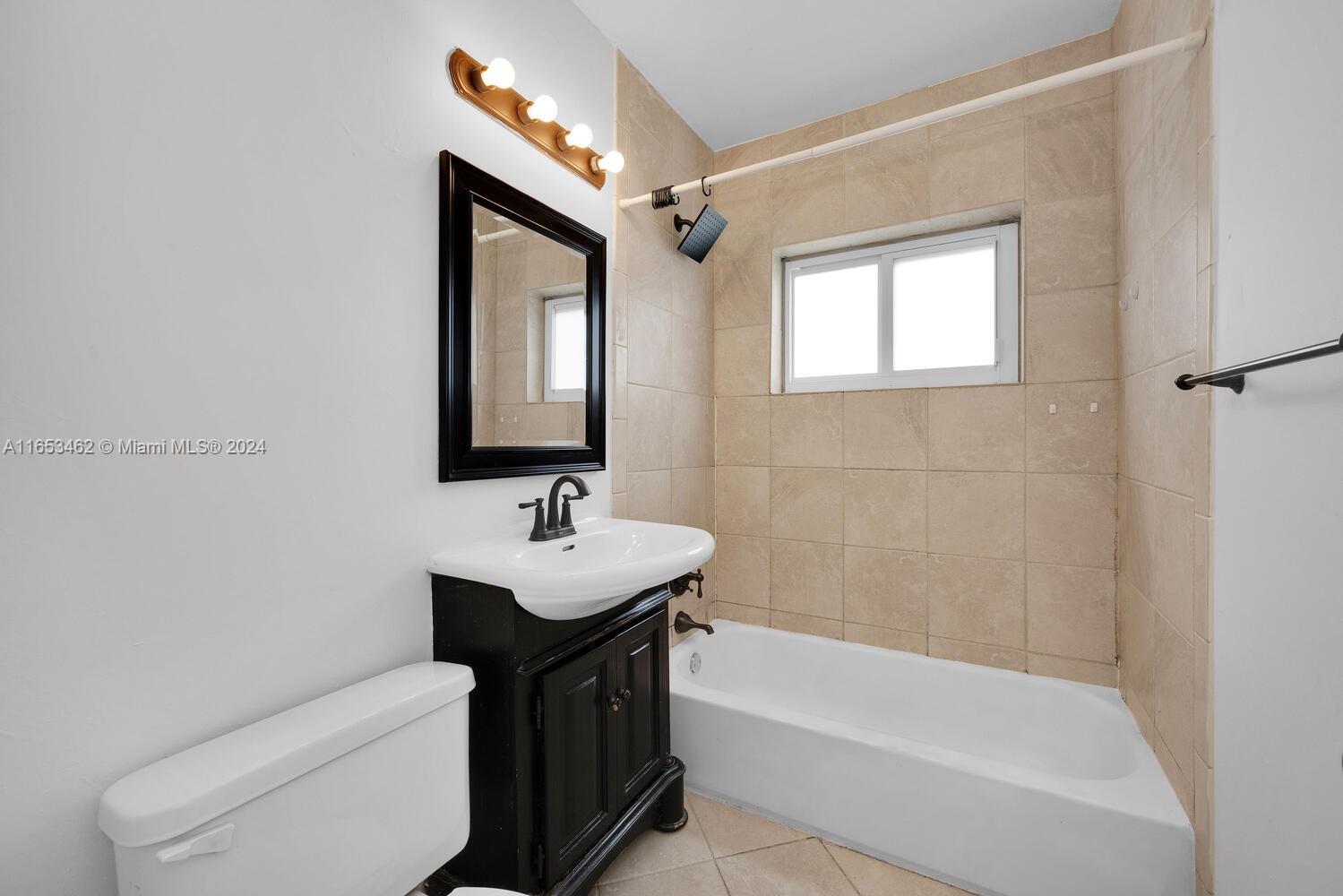 5630 Southwest 76th Street, Unit 3 Miami, FL 33143 - Photo 14 of 16 a bathroom with a sink a toilet and bathtub