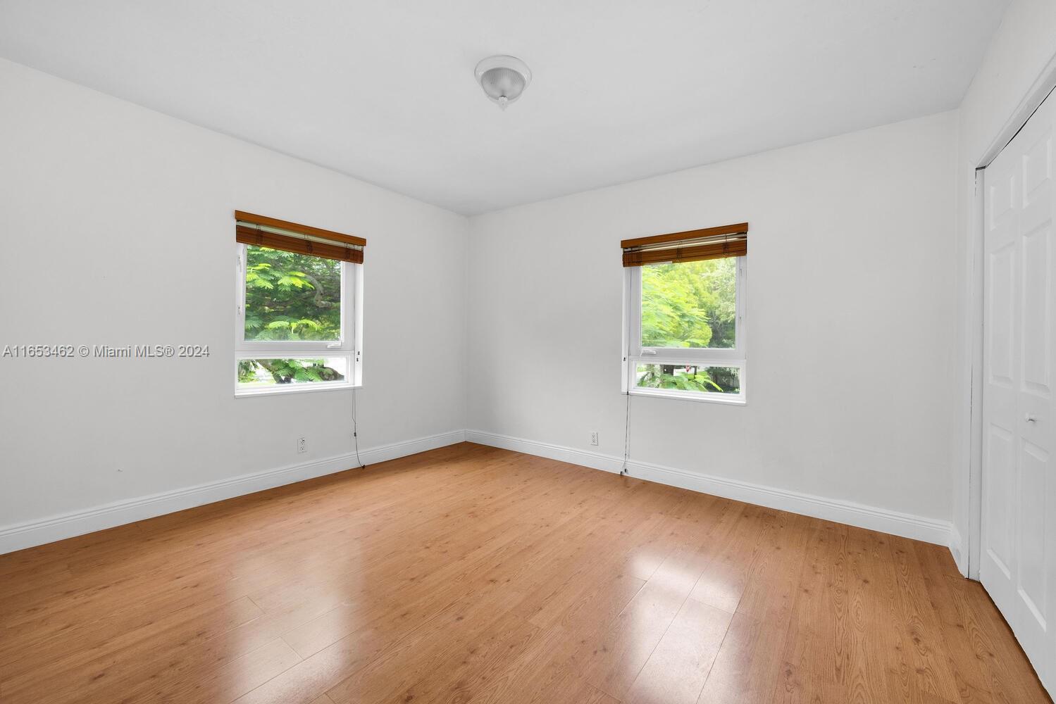 5630 Southwest 76th Street, Unit 3 Miami, FL 33143 - Photo 15 of 16 a view of an empty room with wooden floor and a window