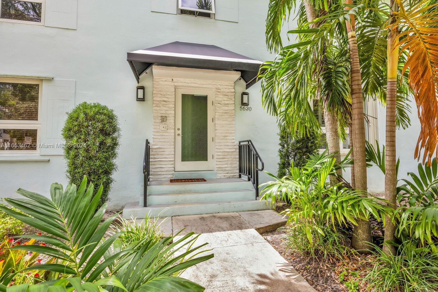 5630 Southwest 76th Street, Unit 3 Miami, FL 33143 - Photo 2 of 16 a front view of a house with a garden