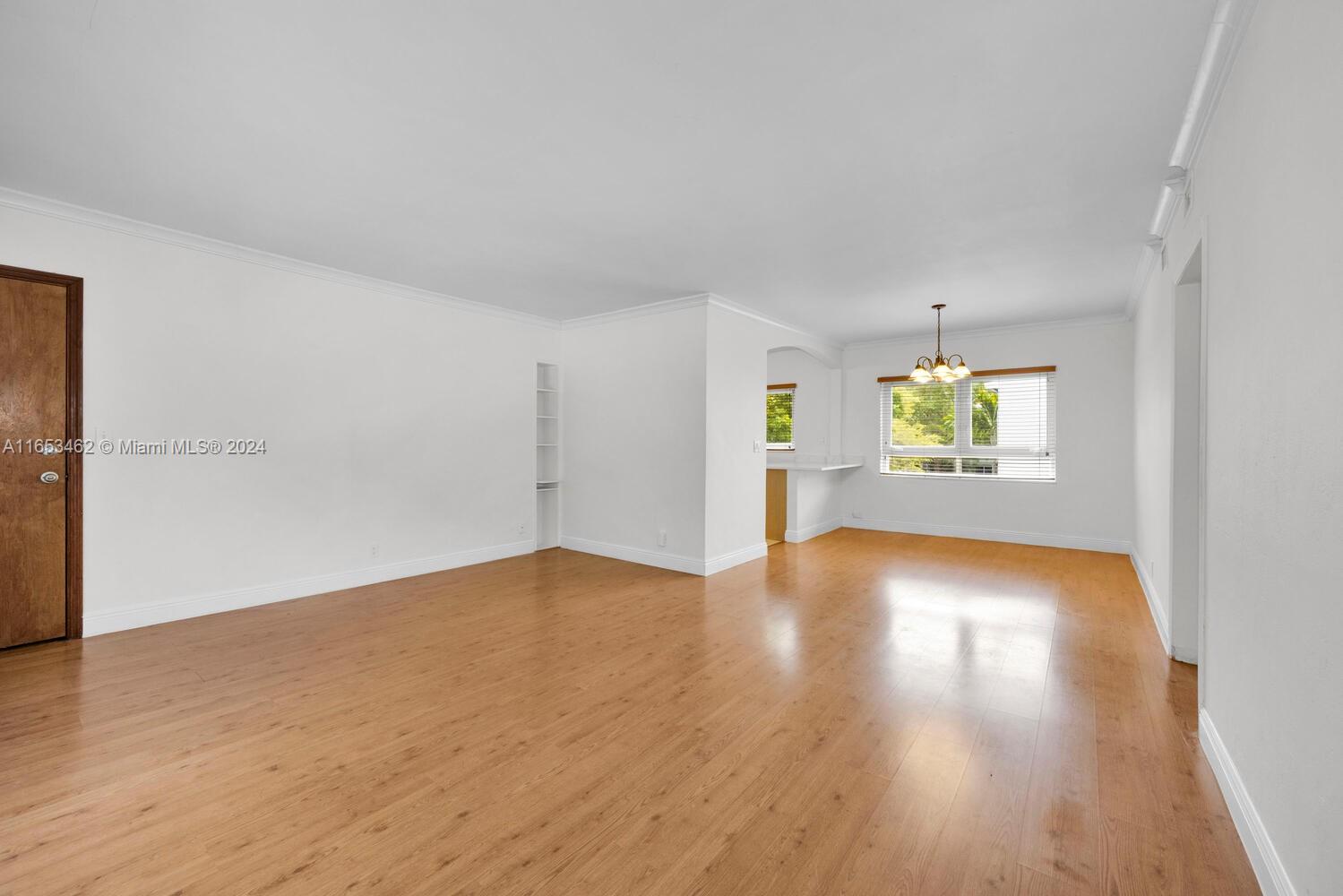 5630 Southwest 76th Street, Unit 3 Miami, FL 33143 - Photo 3 of 16 an empty room with wooden floor and windows