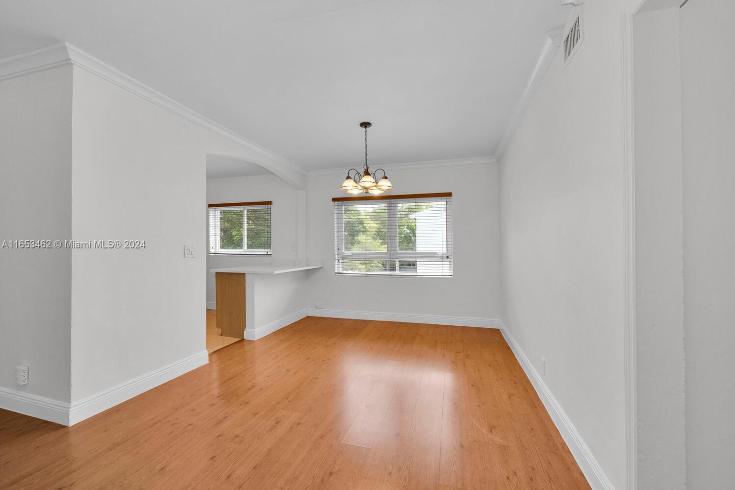 5630 Southwest 76th Street, Unit 3 Miami, FL 33143 - Photo 7 of 16 wooden floor in an empty room with a window