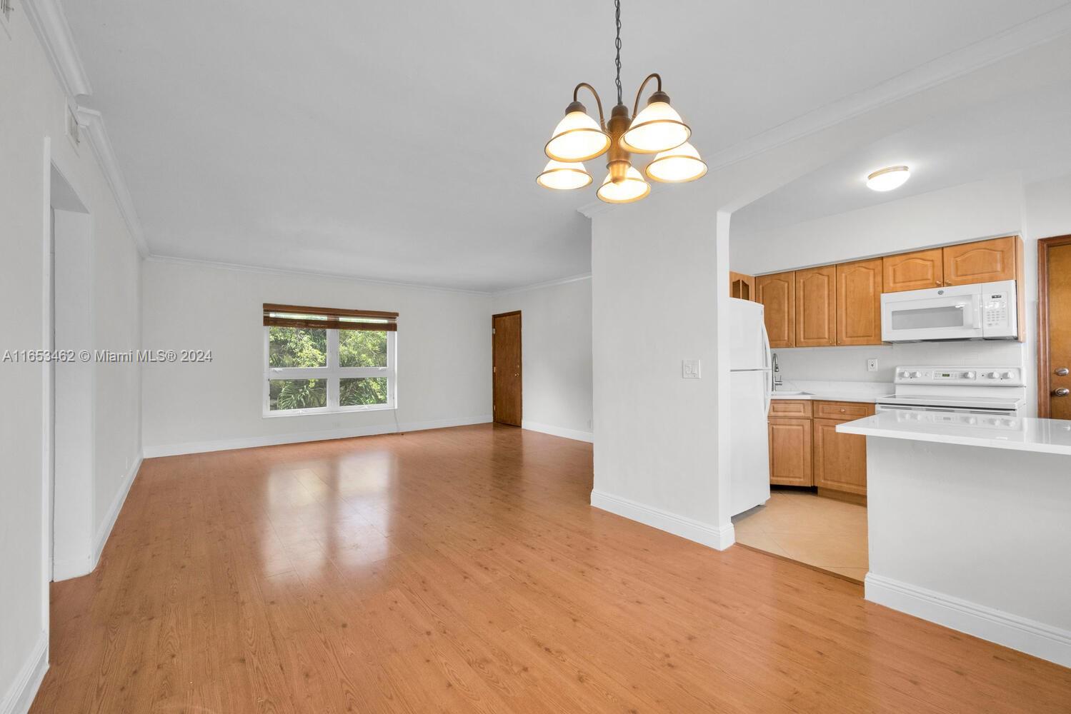 5630 Southwest 76th Street, Unit 3 Miami, FL 33143 - Photo 8 of 16 a view of a kitchen with a sink dishwasher and microwave oven