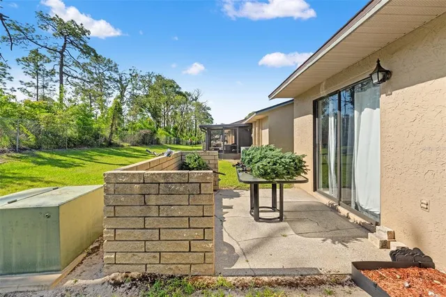 a view of a patio with table and chairs and potted plants