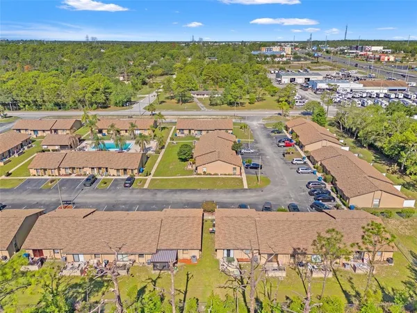 an aerial view of residential houses with outdoor space