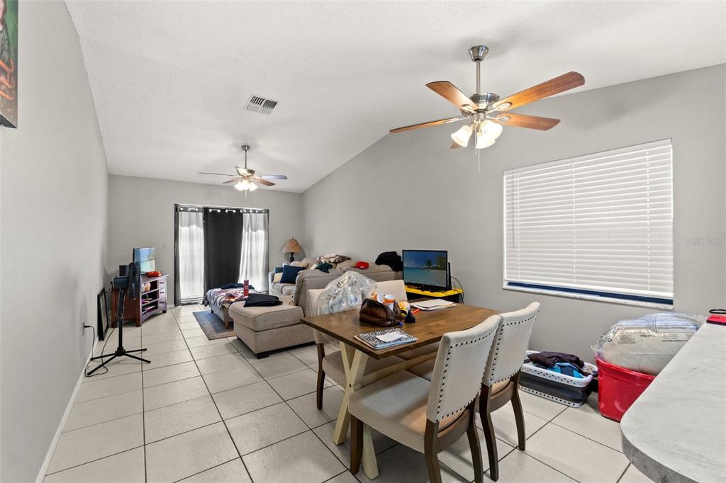 7124 Barclay Avenue, Unit A Spring Hill, FL 34609 - Photo 3 of 22 a living room with furniture a chandelier and a window