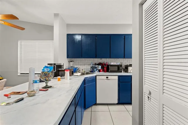a kitchen with a sink a stove and cabinets