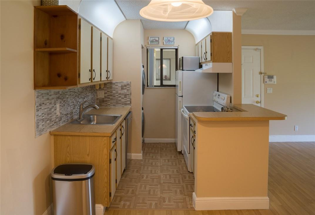 523 Trace Circle, Unit 106 Deerfield Beach, FL 33441 - Photo 14 of 26 a bathroom with a sink a toilet and shower