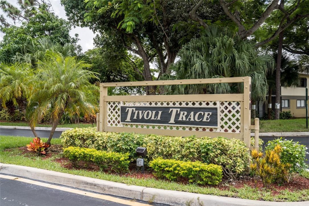 523 Trace Circle, Unit 106 Deerfield Beach, FL 33441 - Photo 2 of 26 a sign on the side of the road