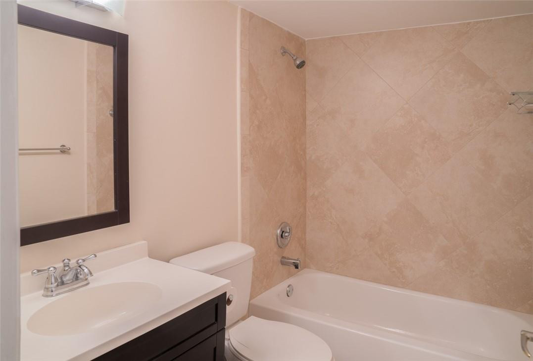 523 Trace Circle, Unit 106 Deerfield Beach, FL 33441 - Photo 23 of 26 a bathroom with a sink and a mirror