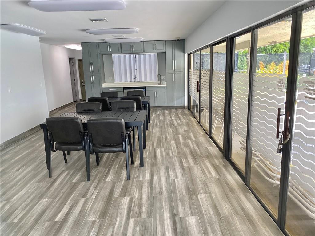 523 Trace Circle, Unit 106 Deerfield Beach, FL 33441 - Photo 25 of 26 a view of a workspace with wooden floor and furniture