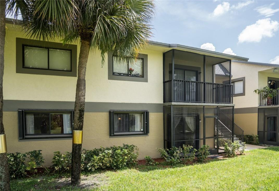 523 Trace Circle, Unit 106 Deerfield Beach, FL 33441 - Photo 4 of 26 a front view of a house with a yard