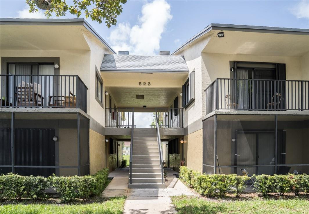 523 Trace Circle, Unit 106 Deerfield Beach, FL 33441 - Photo 5 of 26 a front view of a house with a yard