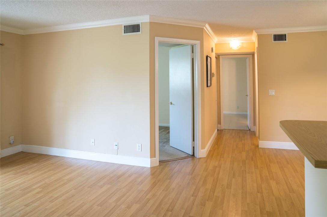 523 Trace Circle, Unit 106 Deerfield Beach, FL 33441 - Photo 9 of 26 wooden floor in an empty room