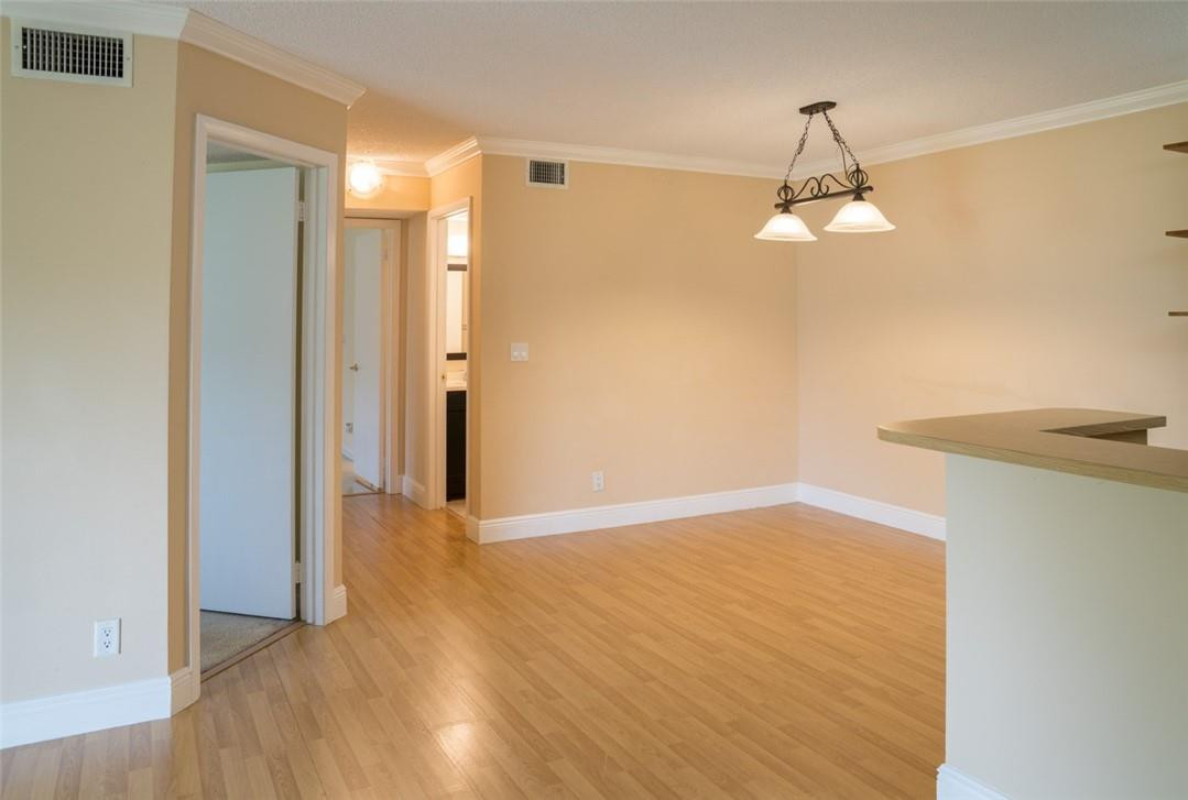 523 Trace Circle, Unit 106 Deerfield Beach, FL 33441 - Photo 10 of 26 a view of empty room with wooden floor and ceiling fan