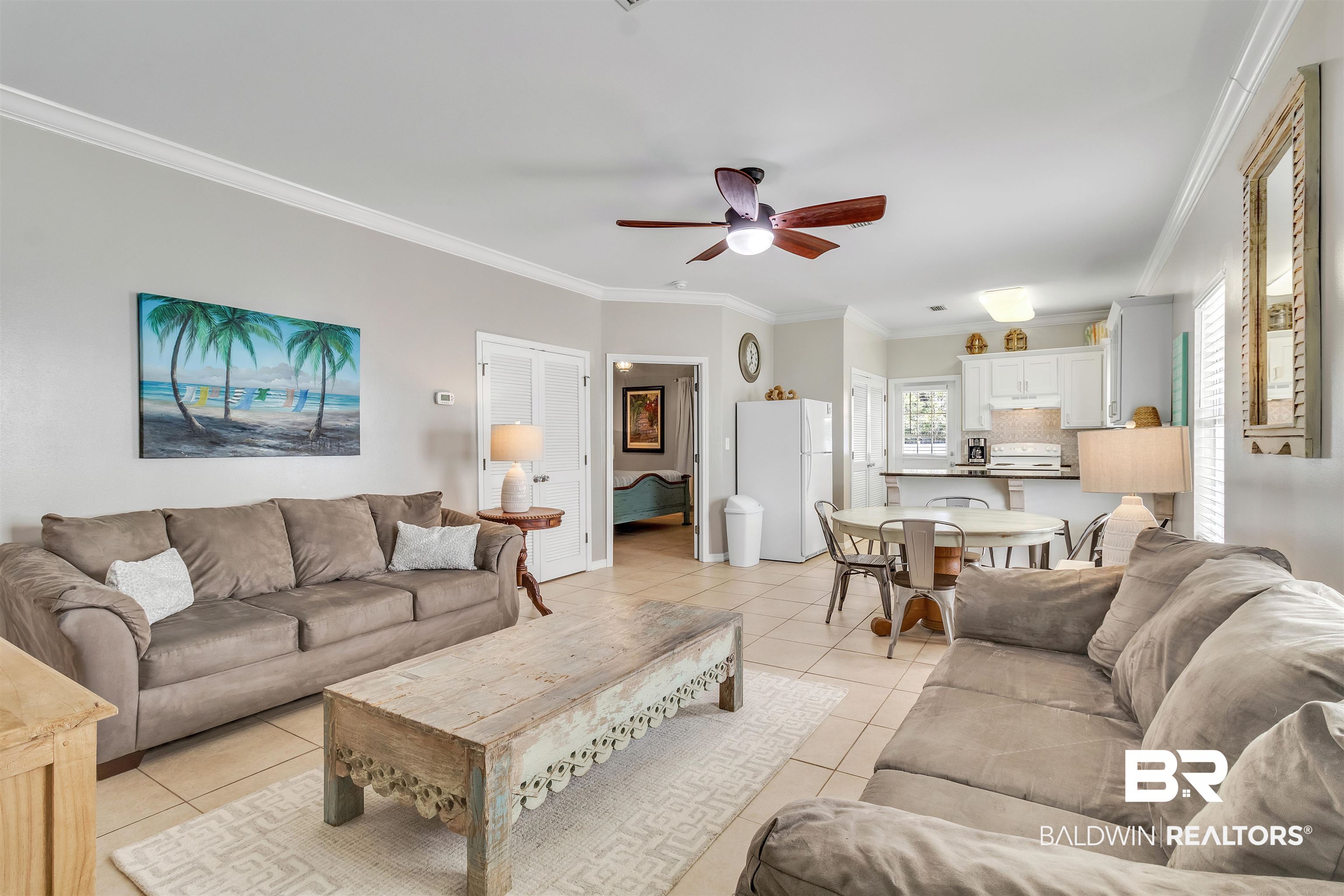 4324 B Lindsey Lane, Unit 4324B Orange Beach, AL 36561 - Photo 10 of 33 Living area with ceiling fan, crown molding, and light tile patterned floors
