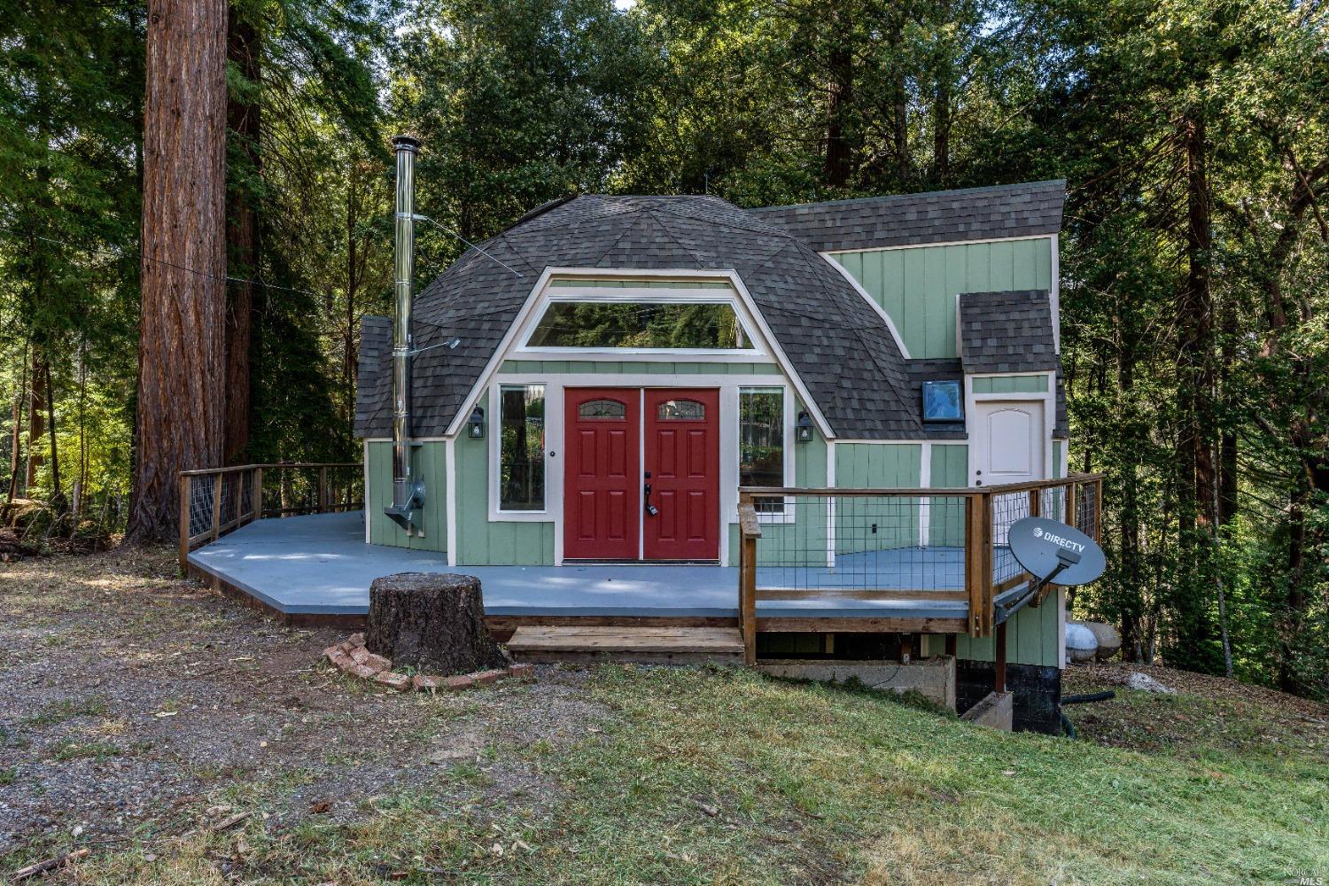 a front view of a house with a garden