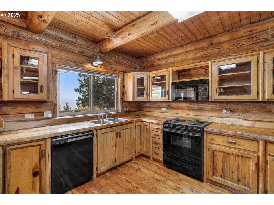 14515 Southwest Maverick Road Terrebonne, OR 97760 - Photo 35 of 39 a kitchen with stainless steel appliances granite countertop a stove sink and cabinets