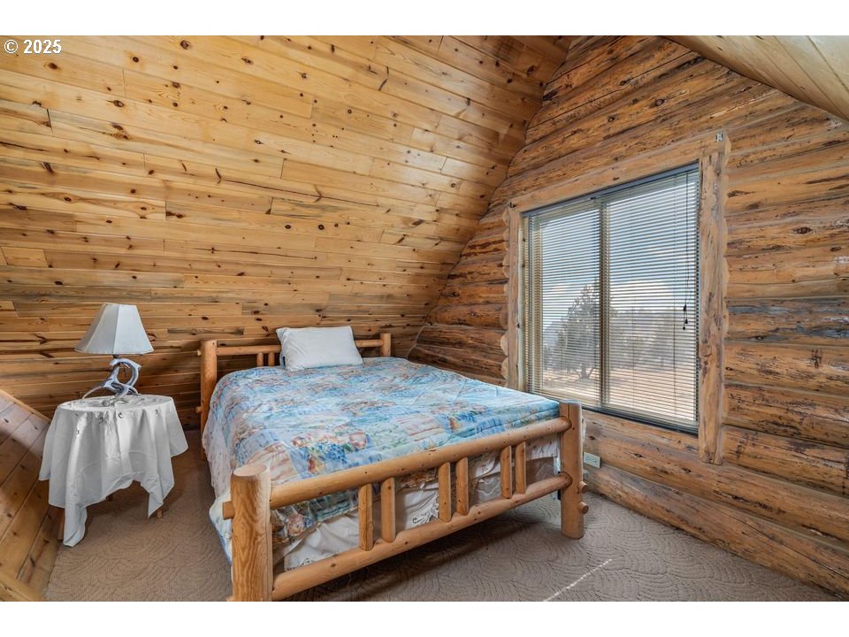 14515 Southwest Maverick Road Terrebonne, OR 97760 - Photo 8 of 39 a bed sitting in a room next to a window