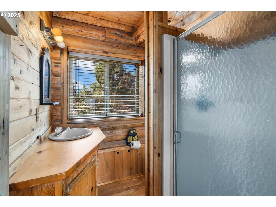 14515 Southwest Maverick Road Terrebonne, OR 97760 - Photo 9 of 39 a bathroom with a granite countertop sink and a mirror